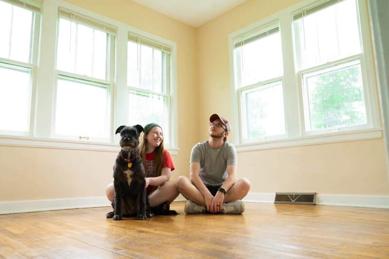 Couple sitting in their new, empty home