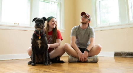 Couple sitting in their new, empty home